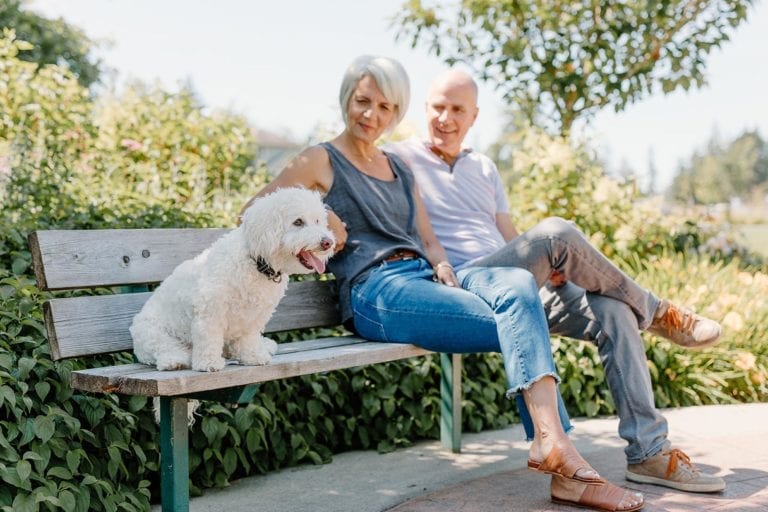 Solaro residents on a bench with dog langley rental apartments